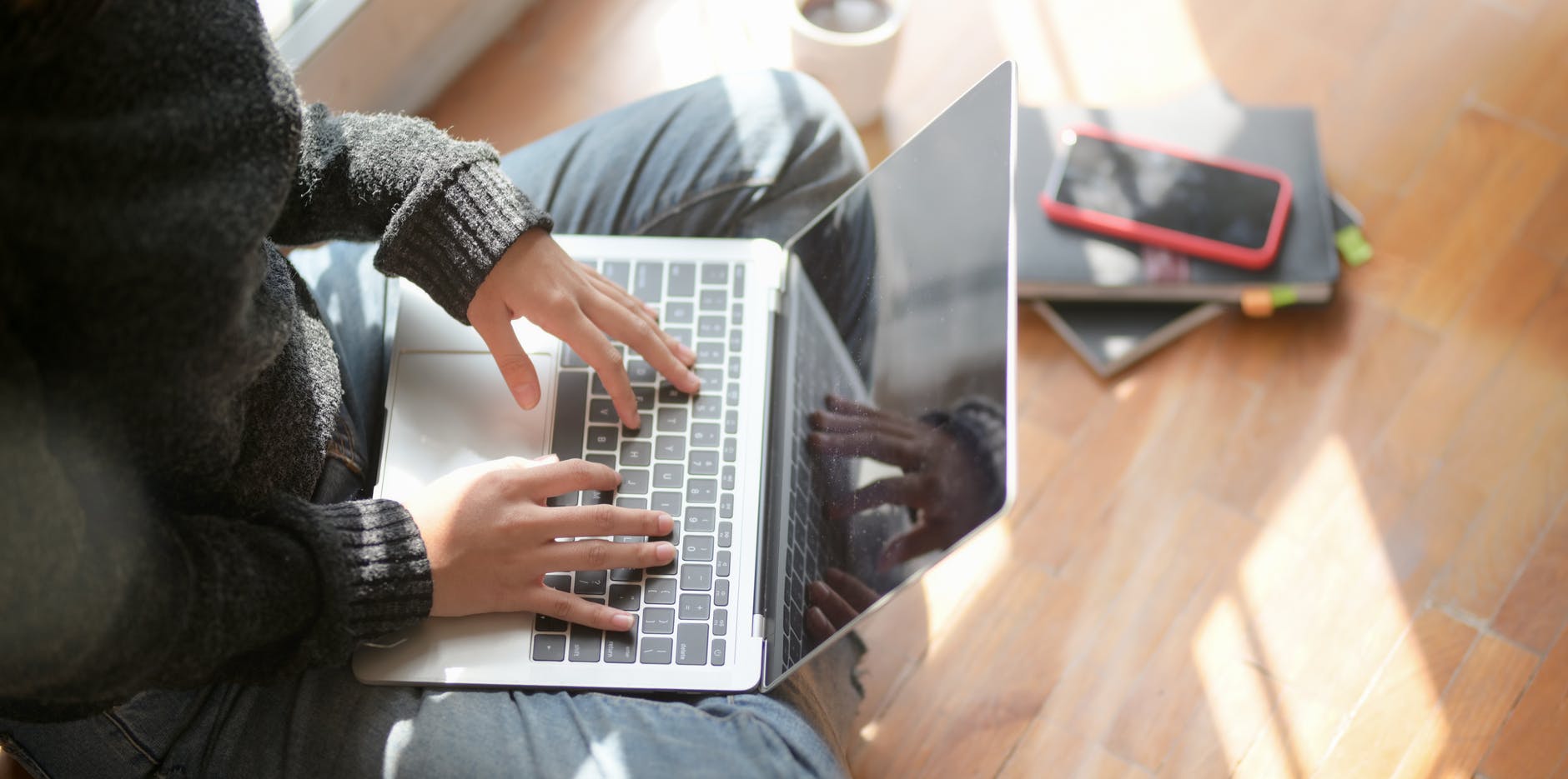  Freelancing Writing woman sitting on hard wooden floor